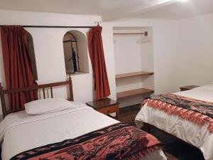Postel nebo postele na pokoji v ubytování Posada Catama INN