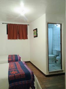 Postel nebo postele na pokoji v ubytování Posada Catama INN