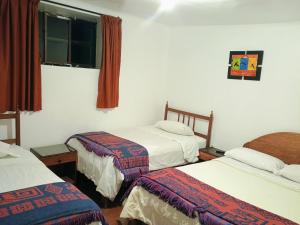 Postel nebo postele na pokoji v ubytování Posada Catama INN
