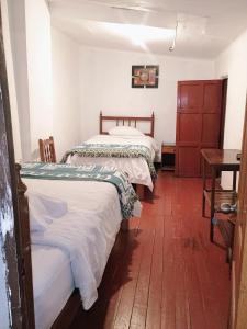 Postel nebo postele na pokoji v ubytování Posada Catama INN