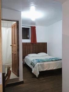 Postel nebo postele na pokoji v ubytování Posada Catama INN