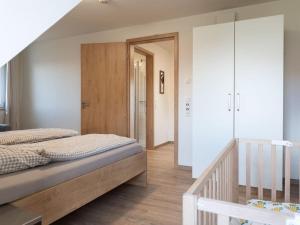 a bedroom with a large bed and a staircase at Oak Comfortable Holiday Residence in Leutkirch im Allgäu