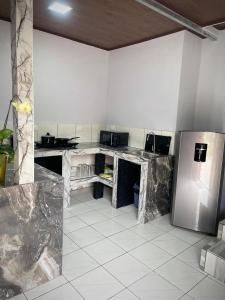 a kitchen with marble counter tops and a stainless steel refrigerator at Villa JADE, La Fortuna Downtown Apartment in Fortuna