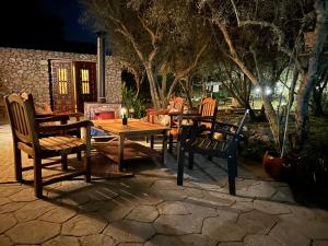 a wooden table and chairs on a patio at night at Casita Balear Sa Coveta in Algaida