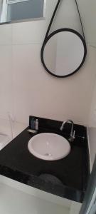 a bathroom with a sink and a mirror on a counter at Zuppolini Garden Hotel in Bananeiras +29 photos