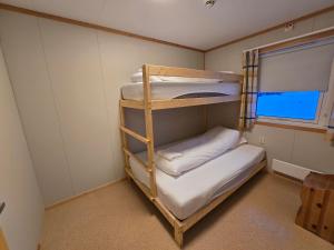 a room with two bunk beds and a window at Tana Familiecamping in Tana
