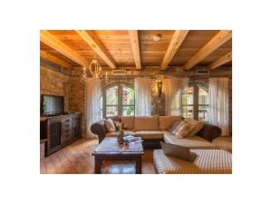 a living room with a couch and a tv at Villa Maccaroni Comfortable holiday residence in Paz