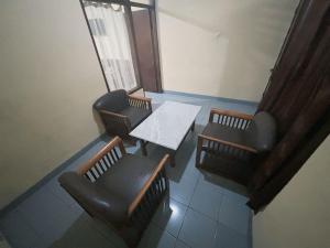 an overhead view of a table and chairs in a room at yaemal frances hotel in Bandung