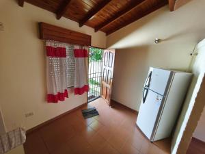 a kitchen with a white refrigerator in a room at Chalet Mar de Ajo in Mar de Ajó