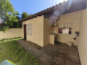 a house with smoke coming out the side of it at Chalet Mar de Ajo in Mar de Ajó +4 photos