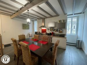 a kitchen and dining room with a table and chairs at Gîte Zen et Confort au cœur du Sud Vendée, proche Parc Natural du Marais Poitevin - FR-1-426-571 in Saint-Hilaire-des-Loges +13 photos