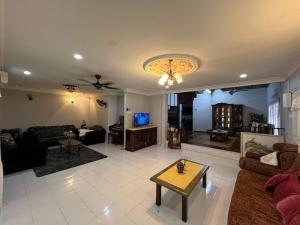a living room with a couch and a table at Seri Selasih Klebang! in Malacca