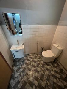 a bathroom with a toilet and a sink at Seri Selasih Klebang! in Malacca