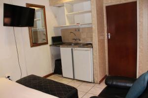 a small kitchen with a sink and a dishwasher at Isabels2 Guest house in Johannesburg