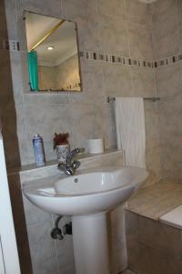 a bathroom with a white sink and a mirror at Isabels2 Guest house in Johannesburg +29 photos