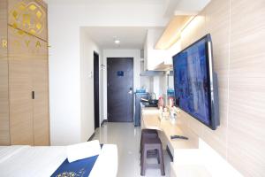 a living room with a large flat screen tv on a wall at Royal Suites Studio 17th Floor - Citra Plaza Nagoya Apartment in Jodoh