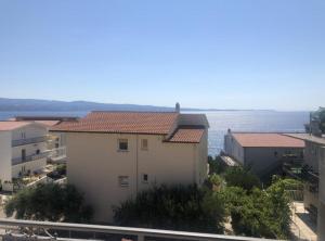 a white building with a view of the ocean at Apartmani Villa Borzic in Omiš