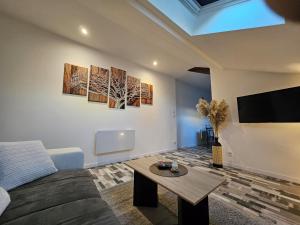 a living room with a couch and a table at Joli appartement mansardé in Decize