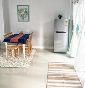 a dining room with a table and a refrigerator at 3 Bedrooms townhome, gated community KKC in Ban Si Than