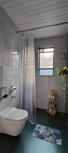 a bathroom with a white bath tub and a window at Paradise Farm Alibaug in Bhāweghar +18 photos