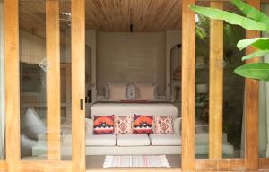 a bed is seen through a glass door at El Salao Villas in El Nido +31 photos