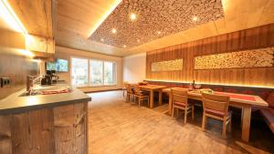 a kitchen with a dining room with tables and chairs at Chalet Alpinhome in Tux