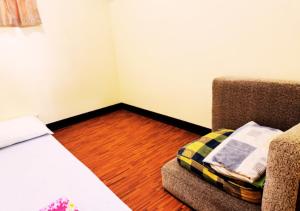 a corner of a room with a bed and a couch at Felicitas Tagaytay in Tagaytay