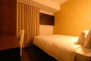 A bed or beds in a room at AB Hotel Kakamigahara