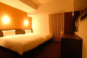 A bed or beds in a room at AB Hotel Kakamigahara