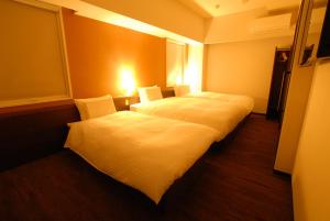 A bed or beds in a room at AB Hotel Kakamigahara