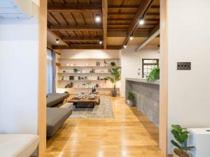 a living room with a couch and a table at お宿Gａｎ錦町 in Takamatsu
