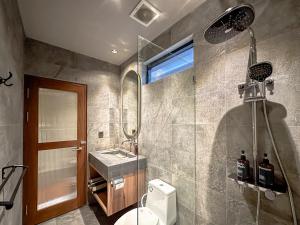 a bathroom with a toilet and a sink and a mirror at Balvanta Coliving in Kerobokan +18 photos