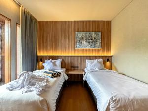two beds sitting next to each other in a room at Balvanta Coliving in Kerobokan