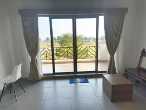 a living room with a large window with a view at Pulicat Lake View Resort APTDC in Tada