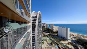 a view of the ocean from the balcony of a building at SUNSET WAVES sea & sky apartment in Benidorm