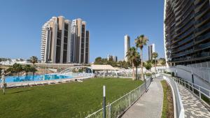 a view of a park with buildings in the background at SUNSET WAVES sea & sky apartment in Benidorm