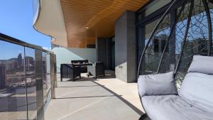 a balcony with a chair and a desk on a building at SUNSET WAVES sea & sky apartment in Benidorm
