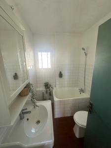 a bathroom with a sink and a tub and a toilet at Studio en plein cœur du village in Saintes-Maries-de-la-Mer