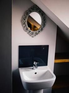 a bathroom with a sink and a mirror at Docker's Digs in Gateshead