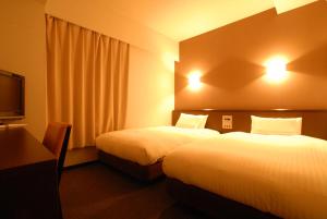 Postel nebo postele na pokoji v ubytování AB Hotel Okazaki