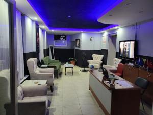 a living room with purple lights on the ceiling at Duygu Otel Konaklama in Karatas