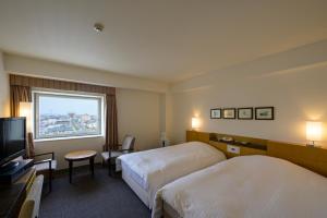 Postel nebo postele na pokoji v ubytování Twin Leaves Hotel Izumo + 37 fotografií
