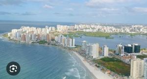 an aerial view of a city with a beach and buildings at Flat hotel number one 403 in São Luís