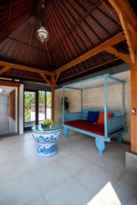 a bedroom with a bed and a table in a room at Lamin Etan Saba Selatan in Keramas +53 photos