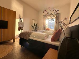 a bedroom with a large bed with a tree on it at Schloß Ort in Passau