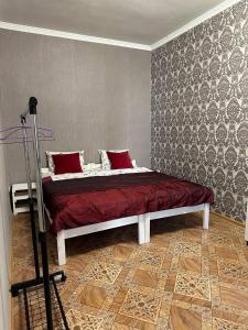 a bedroom with a bed with red pillows on it at Трехкомнатная квартира улица Большая Морская 57 in Mykolaiv