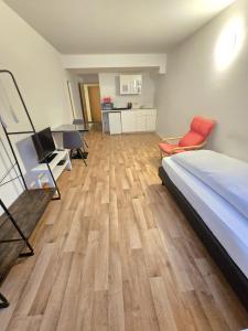 a bedroom with a bed and a desk with a chair at Apartments EFDE Boardinghouse Heilbronn in Heilbronn