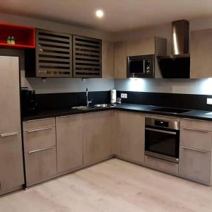 a kitchen with stainless steel appliances and a refrigerator at Haus Wibmer Martin in Matrei in Osttirol