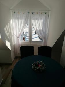 a dining room with a table and a window at Planinska kuća Mitrović in Divčibare