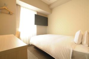Postelja oz. postelje v sobi nastanitve AB Hotel Tahara